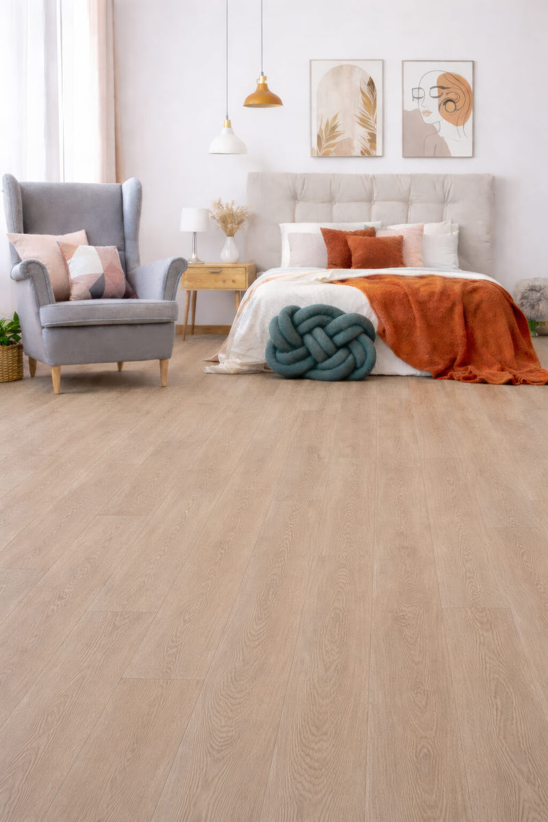 Modern bedroom with Waterblock X Goku brown flooring, gray armchair, and colorful bedding.
