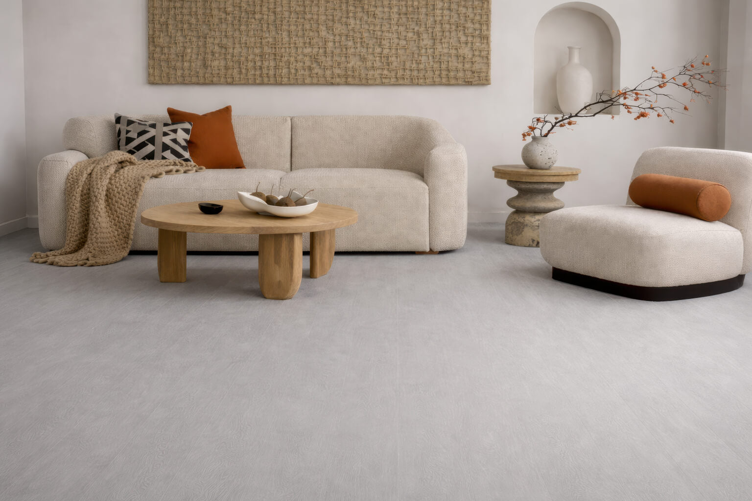 Modern Japanese-themed living room with Waterblock X Kasu light grey stone-look floor, beige sofa, wooden coffee table, and decorative pillows. 
