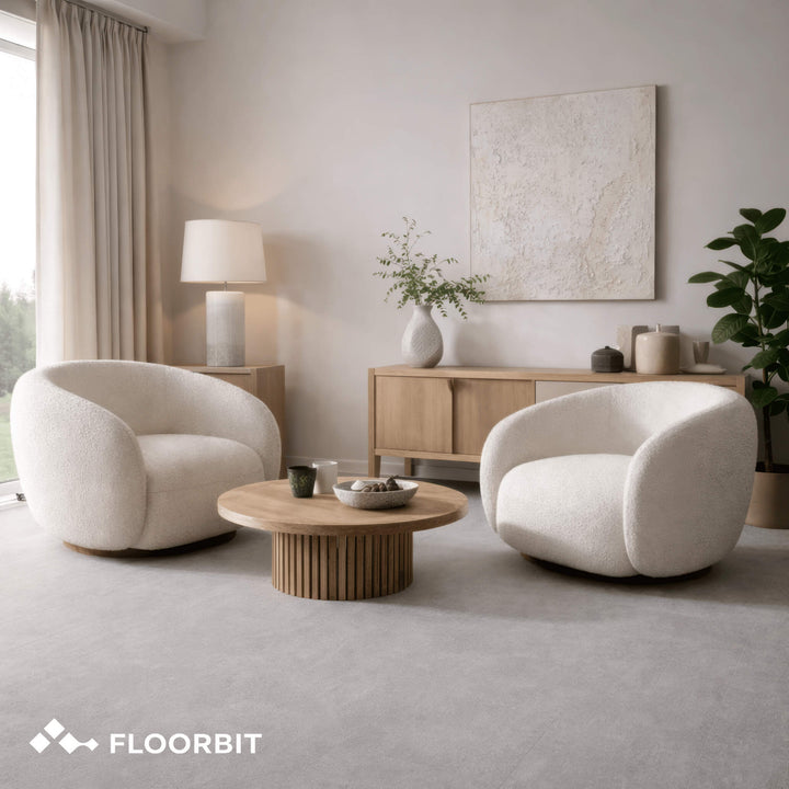 Modern living room with Waterblock X Kasu light grey stone-look floor, two white armchairs, a wooden coffee table, and decorative items.