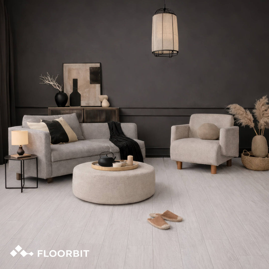 Modern living room with gray sofa, armchair, and round ottoman on a Waterblock X Mizu light brown floor.