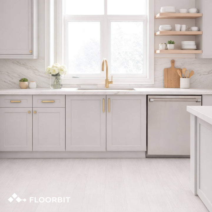 Modern kitchen with Waterblock X Mizu light brown floor, light gray cabinets, white countertops, and a window above the sink.