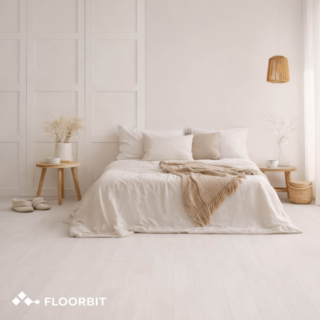 Neatly made bed with white bedding and beige blanket in a minimalistic bedroom with Waterblock X Mizu light brown floor.
